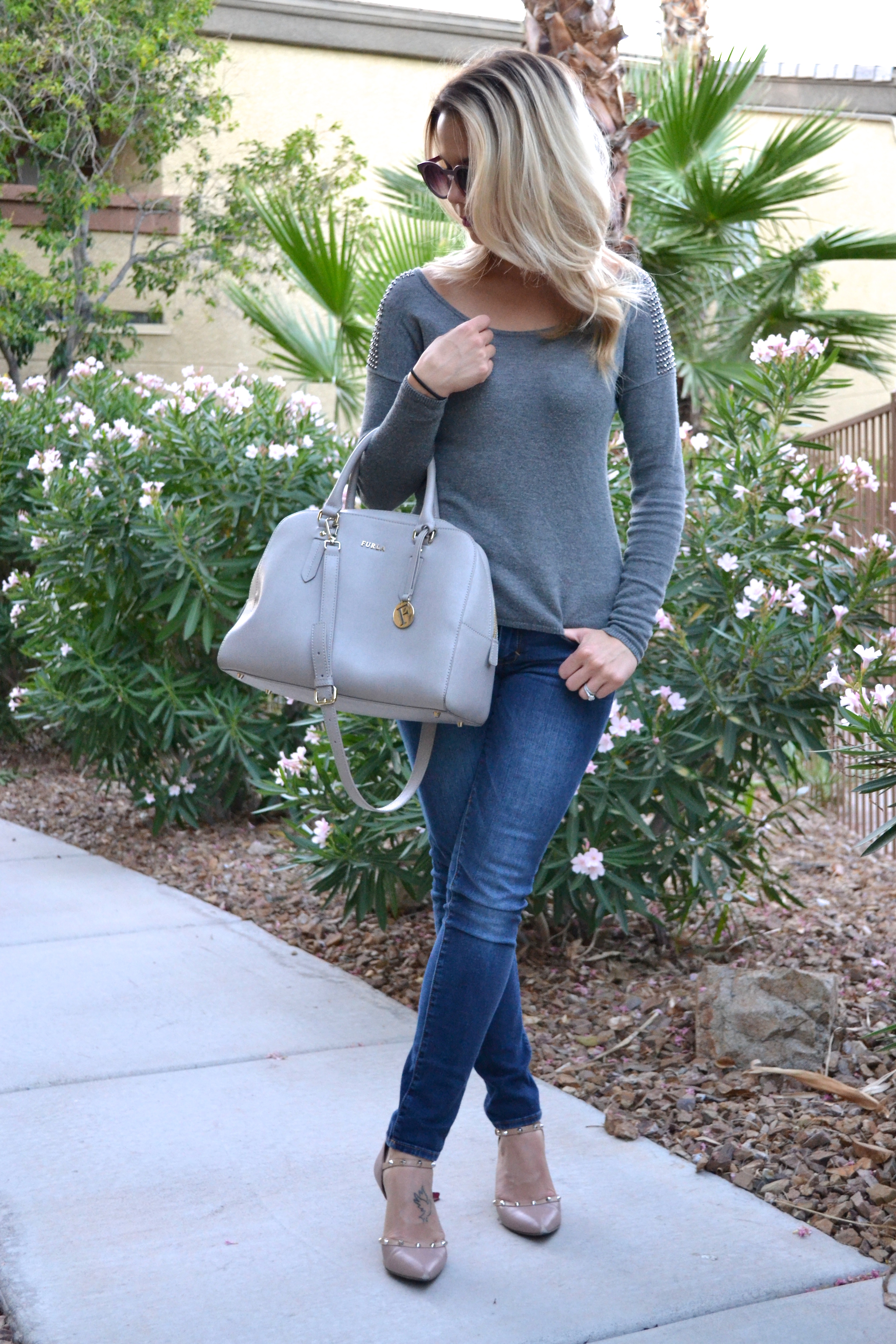 Grey Furla Bag and Grey Sweater and jeans on glamlifeliving.com