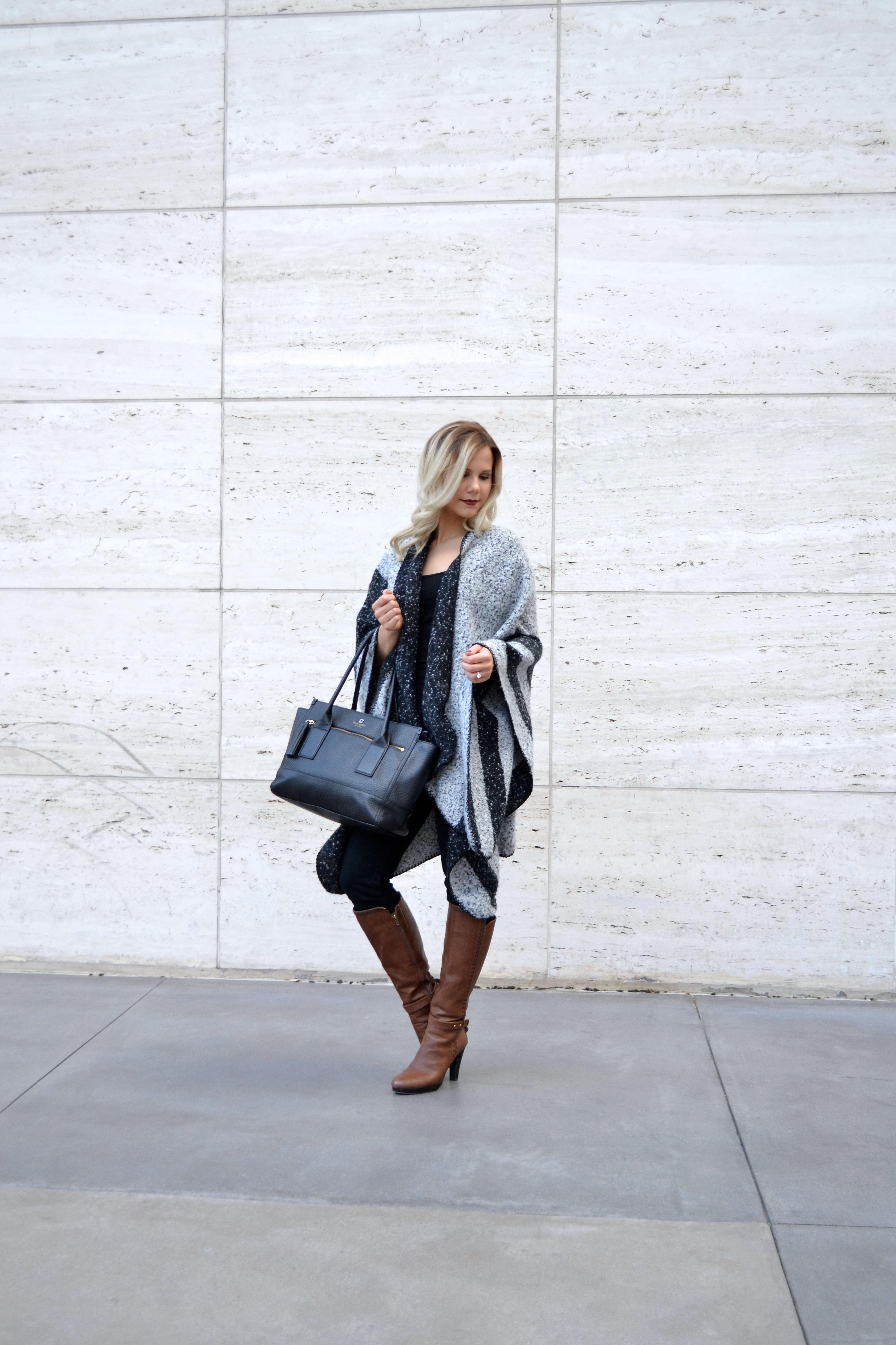 black and grey poncho sweater with brown boots