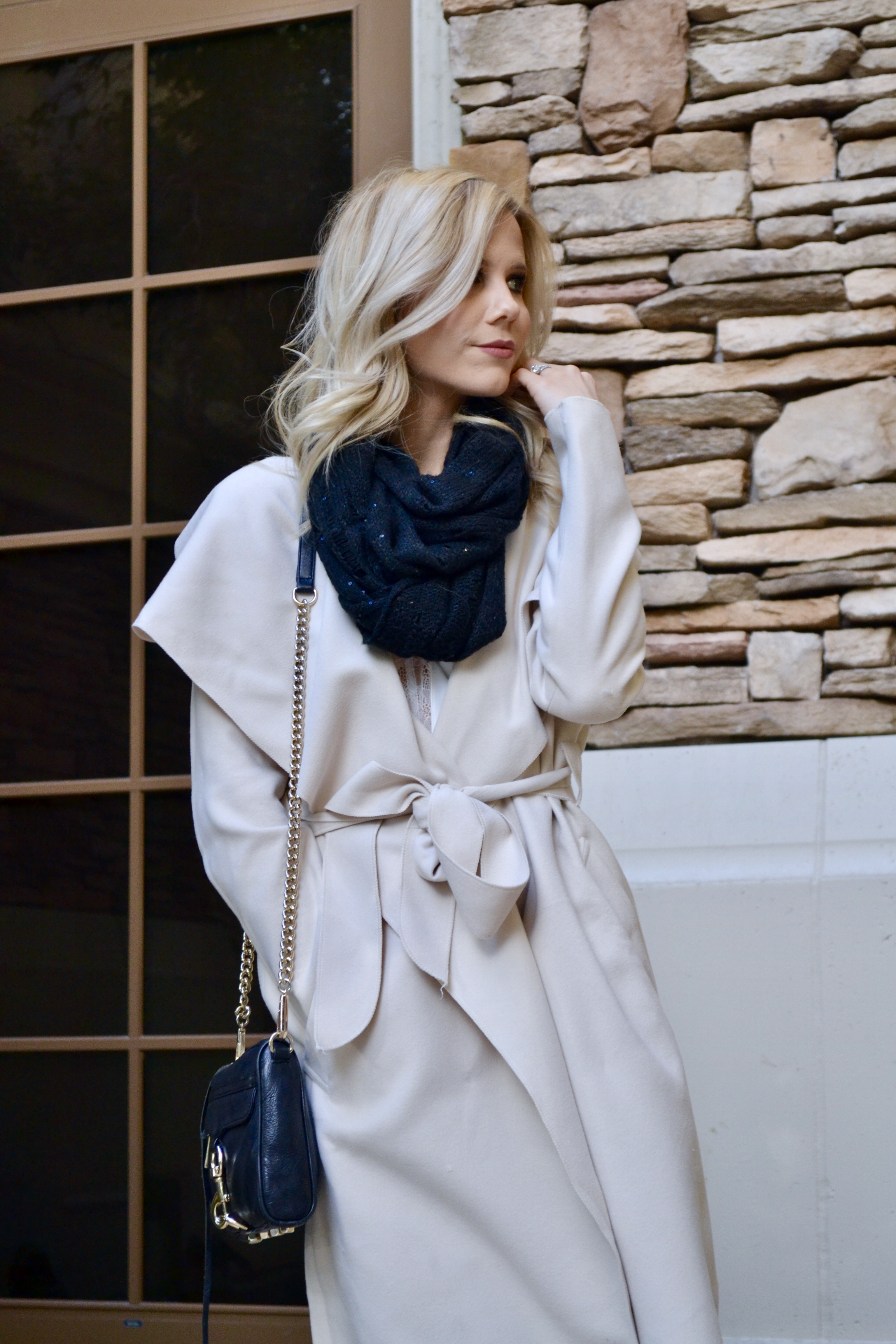 tan wrap coat with black infinity scarf and rebecca mink off bag