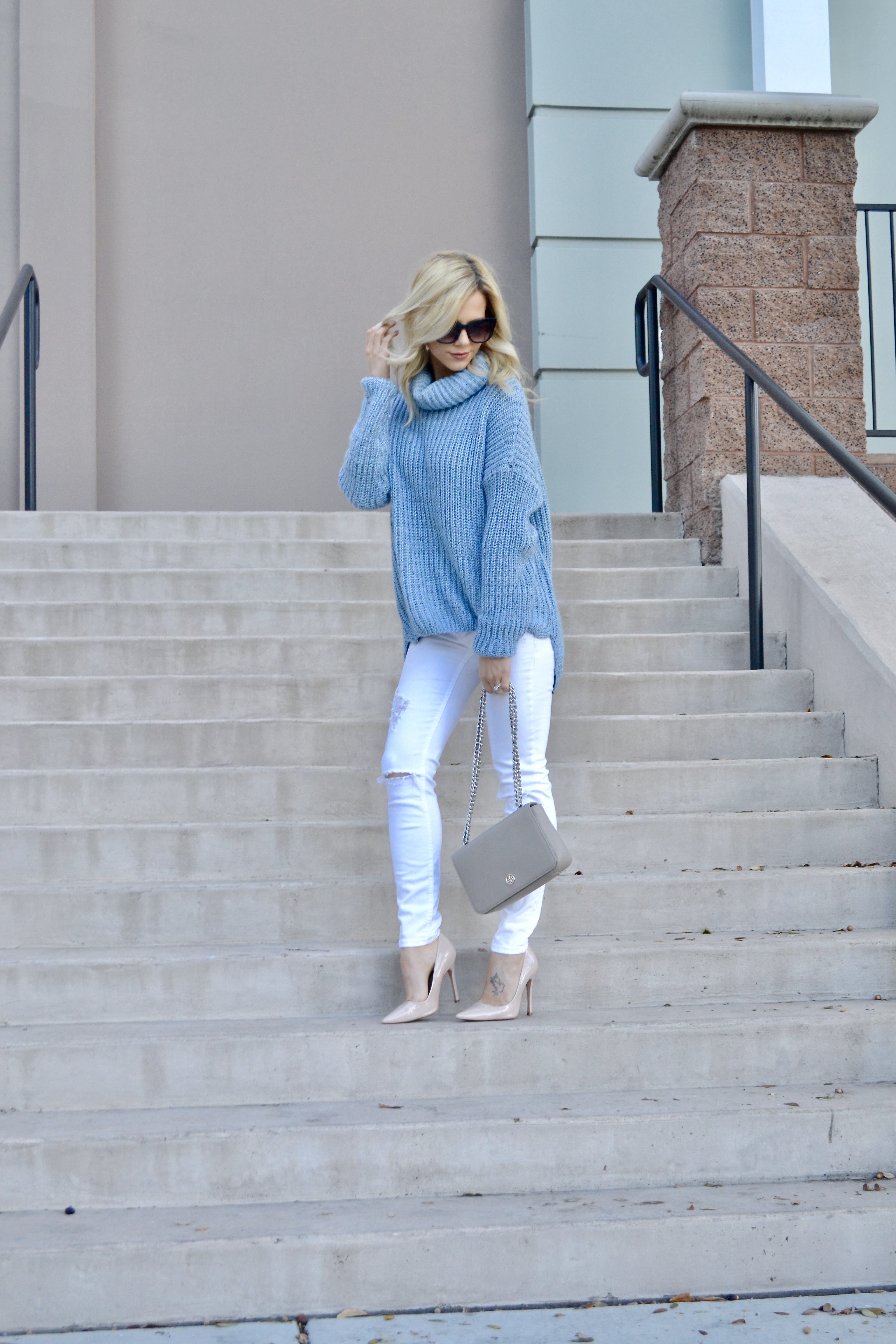 Fashion Blogger Glam Life Living in white jeans, blue sweater, and Tory Burch bag