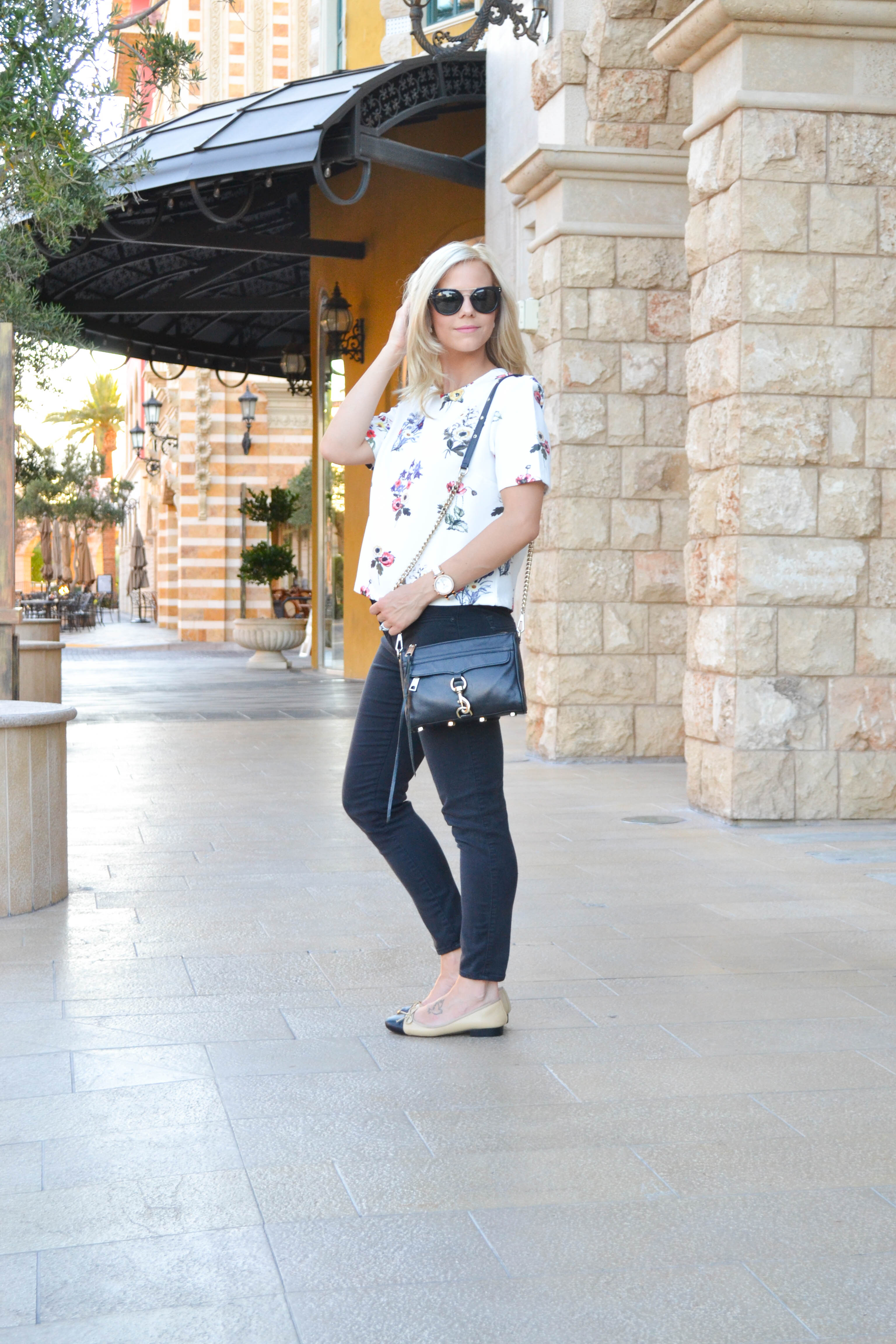 white floral top, black jeans, and chanel flat dupes