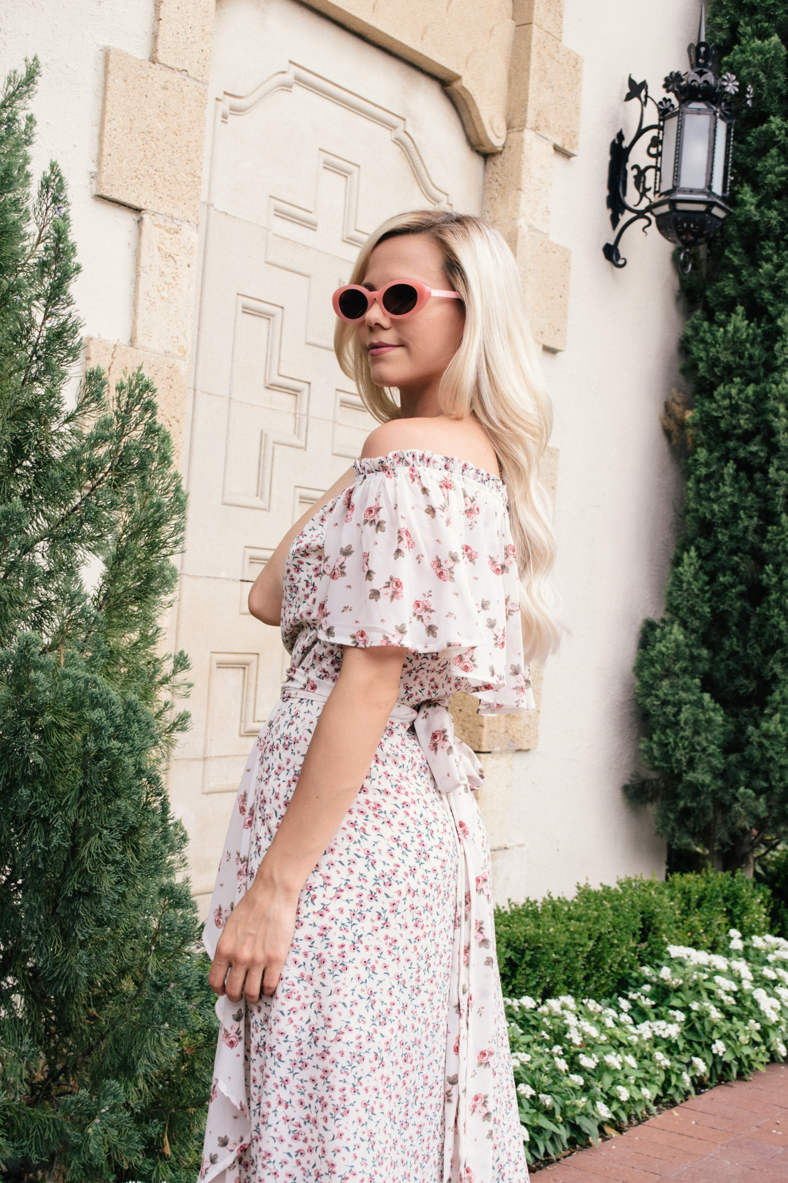 pink contrast floral off the shoulder maxi dress and pink oval sunglasses