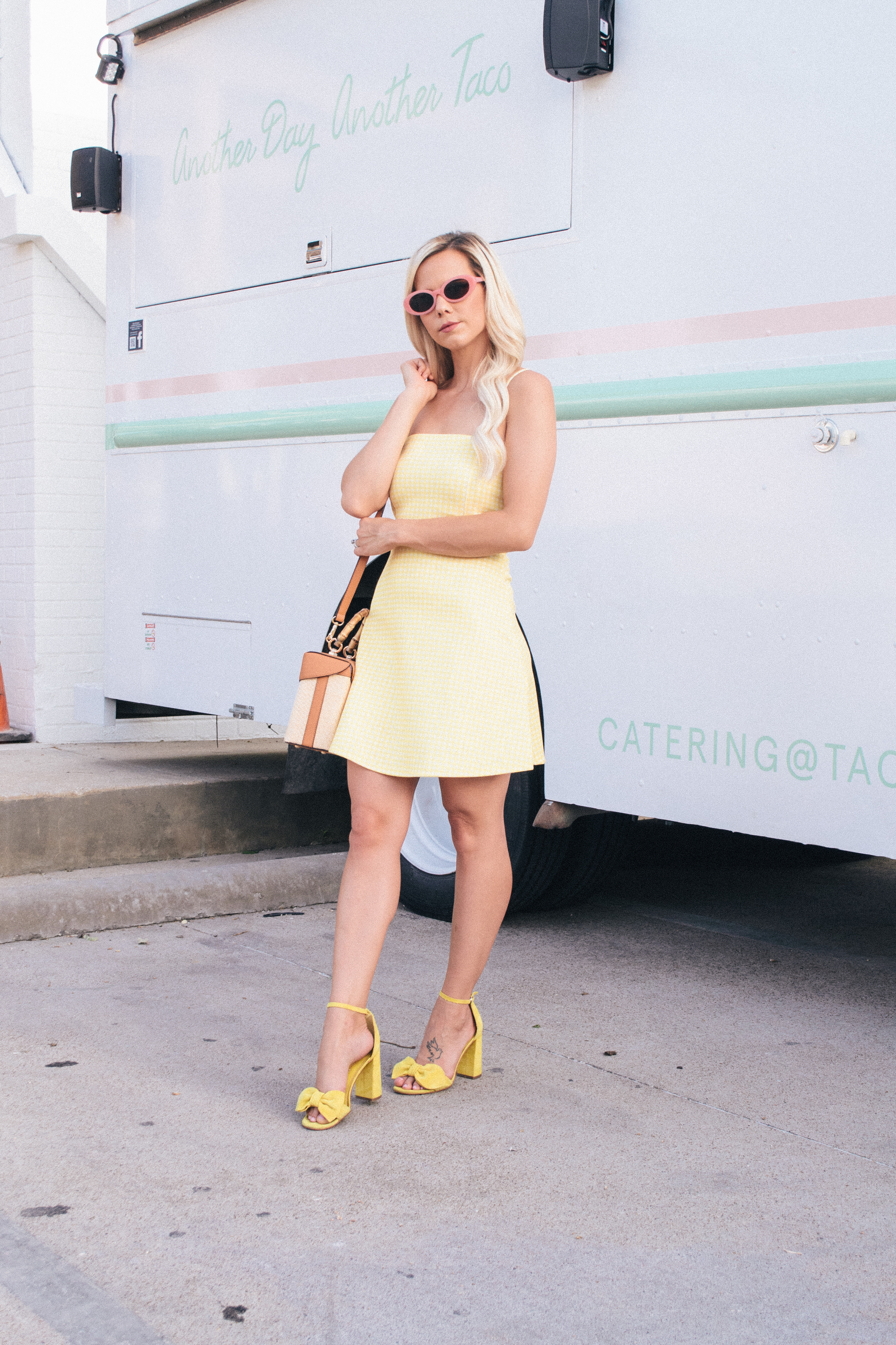 spaghetti strip yellow gingham dress and pink oval sunglasses